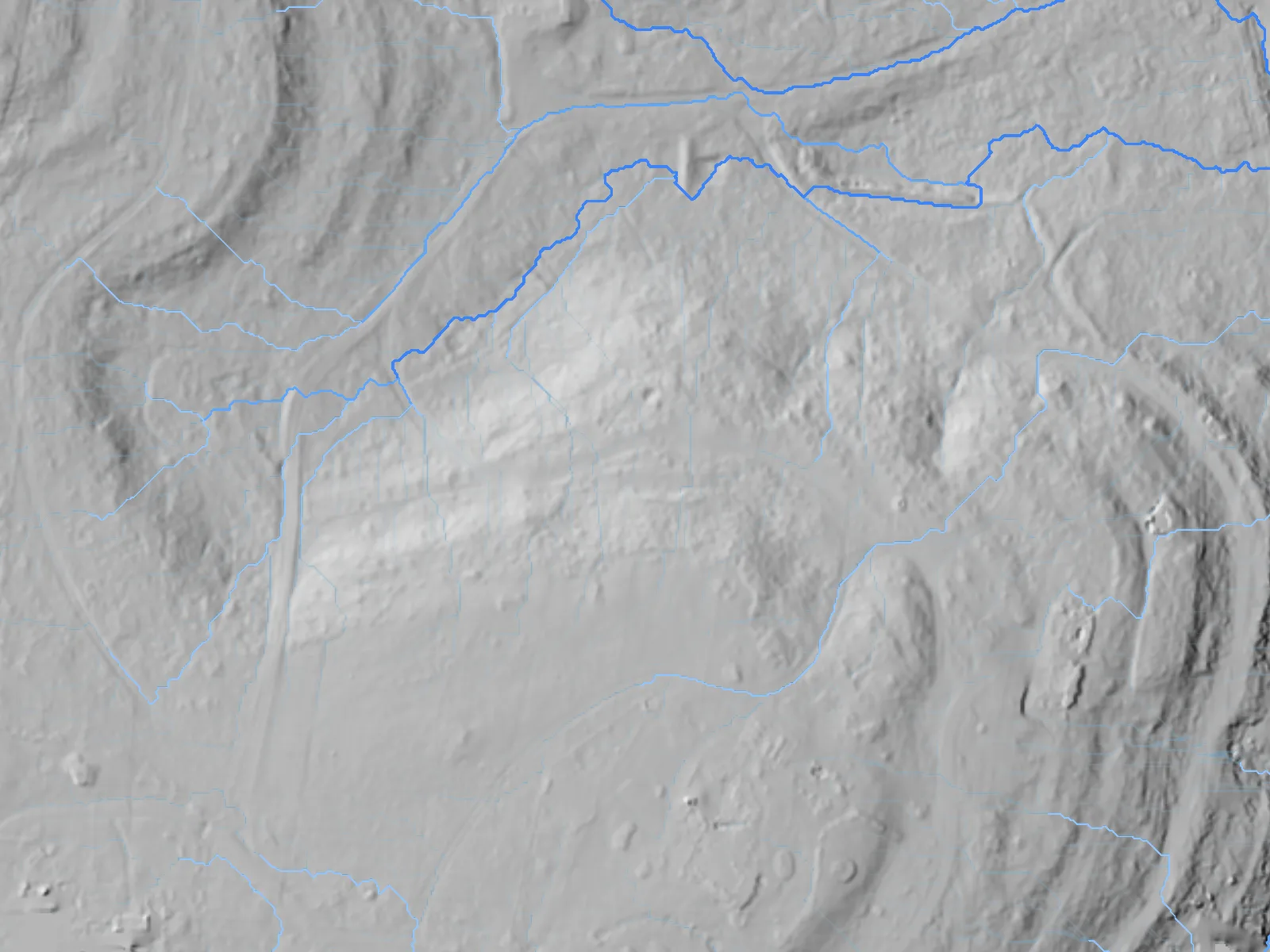Flow accumulation as a blue wash with the ordered channel network drawn through it, on the showcase ranch's bare earth — July 2026 LiDAR scan, modeled.